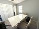 Dining room with a large table, chairs, and a window for natural light at 11303 Hollyglen Dr, Tampa, FL 33624