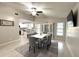 Elegant dining area featuring modern furnishings, an open layout, and easy access to the kitchen at 11303 Hollyglen Dr, Tampa, FL 33624