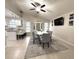 Open-concept dining area adjacent to the kitchen, featuring modern furnishings and a ceiling fan at 11303 Hollyglen Dr, Tampa, FL 33624