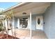 Charming front porch with seating, leading to an elegant front door at 11303 Hollyglen Dr, Tampa, FL 33624