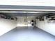 Spacious two car garage with laundry, storage shelving, sealed concrete floor, and painted concrete block walls at 11303 Hollyglen Dr, Tampa, FL 33624