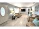 Bright and airy living room featuring light-colored tile floors, comfortable seating, and modern decor at 11303 Hollyglen Dr, Tampa, FL 33624