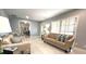 Spacious living room with ample natural light, neutral paint, tile floors, and comfortable furnishings at 11303 Hollyglen Dr, Tampa, FL 33624