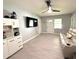 Living room with tile flooring, white furniture, and a ceiling fan at 11303 Hollyglen Dr, Tampa, FL 33624
