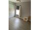 Bright bedroom features wood floors, neutral walls, a large closet, and natural light from a window at 11727 Spanish Lake Dr, Tampa, FL 33635