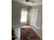 Cozy bedroom featuring wood-look floors, a closet, and a window with natural light at 11727 Spanish Lake Dr, Tampa, FL 33635