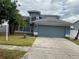 Charming two-story home with a well-manicured lawn, beautiful landscaping, and an attached two-car garage at 11727 Spanish Lake Dr, Tampa, FL 33635
