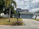 Charming two-story home with a well-manicured lawn, beautiful landscaping, and an attached two-car garage at 11727 Spanish Lake Dr, Tampa, FL 33635
