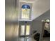 Entryway foyer boasts high ceilings, decorative windows, and a staircase with modern railings at 11727 Spanish Lake Dr, Tampa, FL 33635