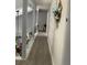 Upstairs hallway with wood-look floors, balcony railings, and decorative flowers and greenery at 11727 Spanish Lake Dr, Tampa, FL 33635