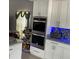 Modern kitchen featuring stainless steel oven appliances and custom cabinets at 11727 Spanish Lake Dr, Tampa, FL 33635