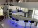 Open-concept kitchen features an island with seating, granite countertops, and stainless steel appliances at 11727 Spanish Lake Dr, Tampa, FL 33635
