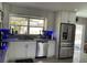 Bright kitchen featuring stainless steel appliances and stone countertops at 11727 Spanish Lake Dr, Tampa, FL 33635