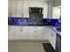 Modern kitchen with stone countertops, custom cabinets, and stainless steel appliances at 11727 Spanish Lake Dr, Tampa, FL 33635
