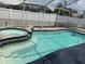 Backyard featuring a screened-in pool and spa, perfect for outdoor relaxation and entertainment at 11727 Spanish Lake Dr, Tampa, FL 33635
