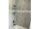 Bathroom shower features tiled walls and a mounted shower rack for added convenience at 11727 Spanish Lake Dr, Tampa, FL 33635
