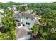 Backyard aerial view highlighting lush greenery and the rear facade of the residence at 124 Estado Ne Way, St Petersburg, FL 33704