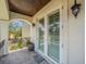 A relaxing balcony features beautiful stonework, stylish wrought iron railing, and shuttered french doors at 124 Estado Ne Way, St Petersburg, FL 33704