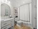 Clean bathroom featuring neutral-toned walls, decorative artwork, and a shower-tub with a curtain at 124 Estado Ne Way, St Petersburg, FL 33704