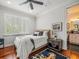 Cozy bedroom with hardwood floors, natural light, and a view to an en-suite bathroom at 124 Estado Ne Way, St Petersburg, FL 33704