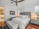 Comfortable bedroom featuring a large upholstered headboard, ceiling fan and bedside tables at 124 Estado Ne Way, St Petersburg, FL 33704