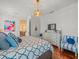 Bright bedroom featuring a geometric patterned bedspread, hardwood floors, and an elegant chandelier at 124 Estado Ne Way, St Petersburg, FL 33704