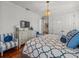 Comfortable bedroom showcasing a dresser with a television, light-colored walls, and bright decor at 124 Estado Ne Way, St Petersburg, FL 33704