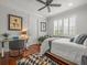 Cozy bedroom with hardwood floors, bright window, and glass desk at 124 Estado Ne Way, St Petersburg, FL 33704