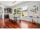 Bright dining room with hardwood floors, modern chandelier, and large window at 124 Estado Ne Way, St Petersburg, FL 33704