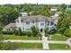 Stunning home with a tile roof, lush landscaping, manicured lawn, and mature trees at 124 Estado Ne Way, St Petersburg, FL 33704