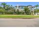 Beautiful home features mature landscaping, a covered balcony, and manicured lawn at 124 Estado Ne Way, St Petersburg, FL 33704