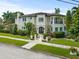 Elegant two-story home boasting lush landscaping, a balcony, and classic architectural details at 124 Estado Ne Way, St Petersburg, FL 33704