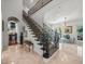 Elegant foyer with beautiful staircase and view into the living area at 124 Estado Ne Way, St Petersburg, FL 33704