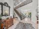 Grand foyer featuring a staircase with ornate wrought iron railings and light-filled space at 124 Estado Ne Way, St Petersburg, FL 33704