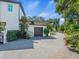 A detached garage has a brick driveway and manicured landscaping at 124 Estado Ne Way, St Petersburg, FL 33704