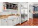 Modern kitchen with stainless steel refrigerator, sink, and built-in shelving at 124 Estado Ne Way, St Petersburg, FL 33704