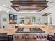 High-end kitchen with stainless steel range, custom hood, and granite countertops at 124 Estado Ne Way, St Petersburg, FL 33704