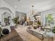 Bright living room featuring marble floors, iron staircase and a modern light fixture at 124 Estado Ne Way, St Petersburg, FL 33704