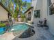 Beautiful pool area featuring a spa and waterfall, surrounded by lush tropical landscaping at 124 Estado Ne Way, St Petersburg, FL 33704