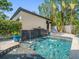 Inviting pool area with a tranquil waterfall feature, lush greenery, and ample space for lounging and relaxation at 124 Estado Ne Way, St Petersburg, FL 33704