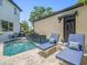 Relaxing backyard pool area with lounge chairs, a water feature, and privacy fencing at 124 Estado Ne Way, St Petersburg, FL 33704