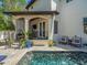 Inviting pool area with covered seating, lush landscaping, and tiled deck, great for entertaining at 124 Estado Ne Way, St Petersburg, FL 33704