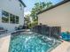 Private backyard pool with a waterfall feature, mature trees and serene backyard views at 124 Estado Ne Way, St Petersburg, FL 33704