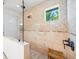 Detailed shower features diamond pattern tile, seating and shower window at 124 Estado Ne Way, St Petersburg, FL 33704