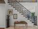 Close-up view of the ornate wrought iron staircase with neutral decor at 124 Estado Ne Way, St Petersburg, FL 33704