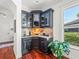 A wet bar with stylish cabinetry, granite countertops and backsplash and wine storage at 124 Estado Ne Way, St Petersburg, FL 33704