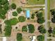 Aerial view of property showing the roof, trees, surrounding land, and pond at 12502 Tocci Ln, Riverview, FL 33579