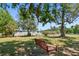 Backyard featuring a wood swing hanging from the branches of a mature tree at 12502 Tocci Ln, Riverview, FL 33579