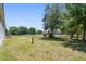 Spacious fenced backyard featuring a large shade tree and lush green grass at 12502 Tocci Ln, Riverview, FL 33579