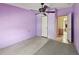 Bedroom with purple walls, light floors, and access to another room at 12502 Tocci Ln, Riverview, FL 33579